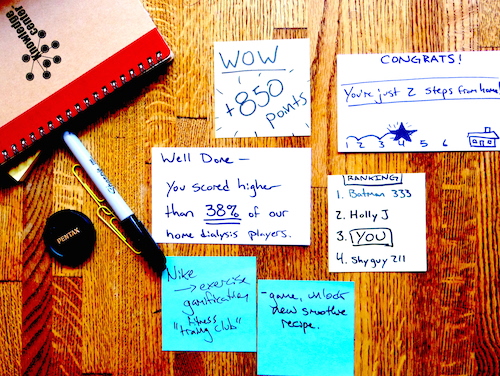 A Pocketknife-branded notebook beside handwritten research artifacts — scoring and feedback cards from the Home Dialysis Plus project.